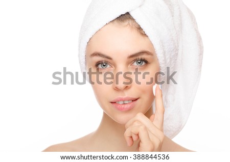 Young woman with cosmetic  cream on a clean fresh face. Skin care concept