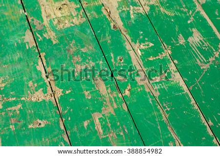 Green painted pale and worn hardwood planks surface as background image