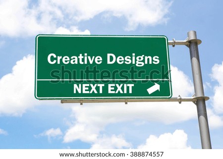 Green overhead road sign with a Creative Designs Next Exit concept against a partly cloudy sky background.