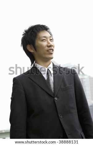 A businessman standing by the river