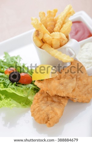 Fish dish - fried fish fillet with vegetables on white tray