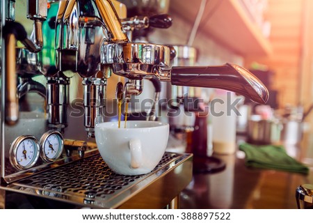 Professional coffee machine making espresso in a cafe Royalty-Free Stock Photo #388897522
