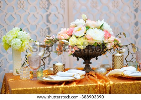 Stylish golden table set with natural flowers