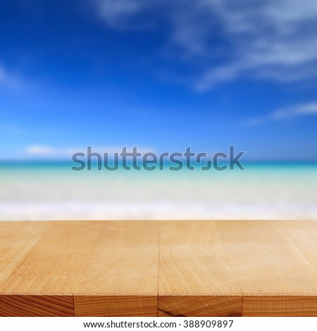 Wood table on blurred beach background.Summer concept.