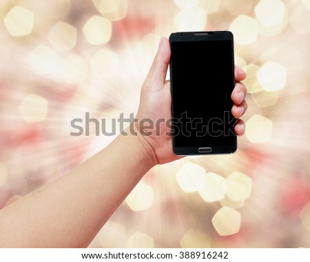 Handle phone golden bokeh background. Business Communications