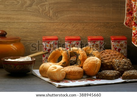 Many mixed bread and rolls on the table in the kitchen