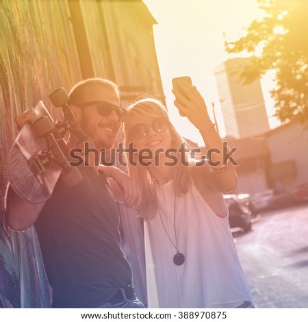 Urban couple doing selfie outdoors.