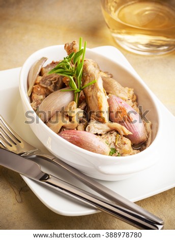 Rabbit prepared with onions and mushrooms