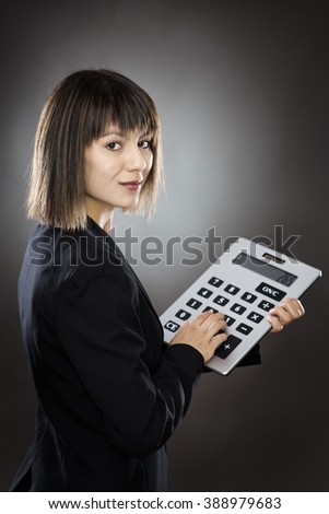 business woman using a large calculator