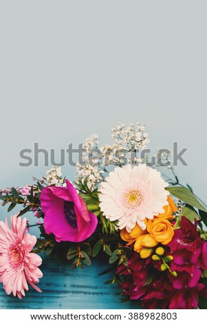 Fresh spring flowers on turquoise background.