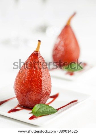 A dessert of sweet pears cooked in red wine