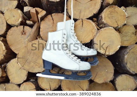 Pair of White Ice Skates and Santa Claus hat - background on vintage, retro style.