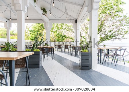 cafe by the sea, summer terrace, empty table Royalty-Free Stock Photo #389028034