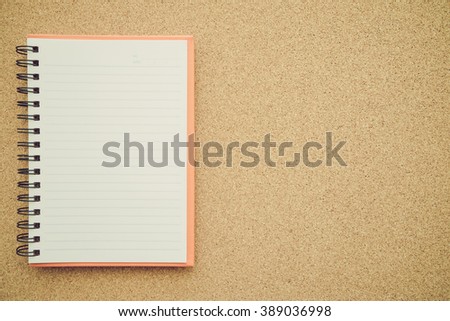 Blank empty notepad on cork board