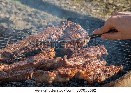 Closeup of meat cooking in the barbecue outdoor