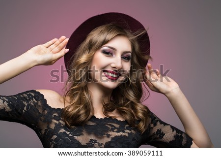 young girl with a beautiful smile and maroon hat