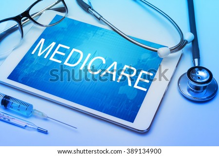 Medicare word on tablet screen with medical equipment on background Royalty-Free Stock Photo #389134900