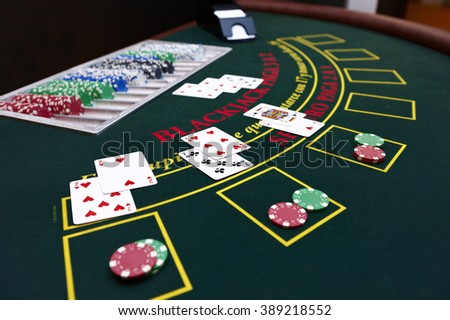 Black Jack table with cards and tokens Royalty-Free Stock Photo #389218552