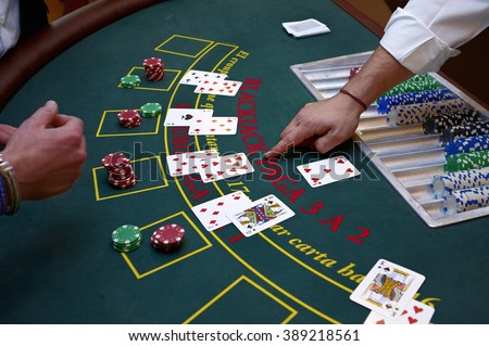 A close up of a blackjack dealer's hands in a casino, very shallow depth of field Royalty-Free Stock Photo #389218561