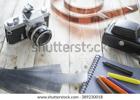 Vintage still-life with old retro cameras on a wooden table