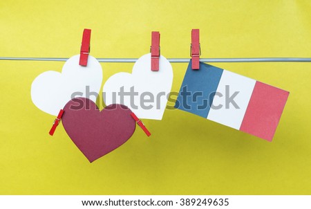 white paper sticker (space for text), France flag hanging pegs. Concept - wishes for the holidays, information text, messages. toned colored