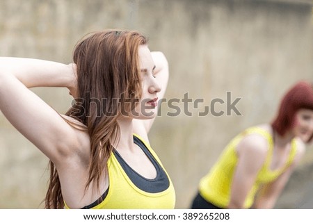 Young women stretching outdoors