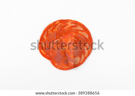 slices of chorizo salami on white background
