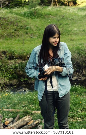 stylish couple camping, girl with analog photo camera in spring sunny mountains