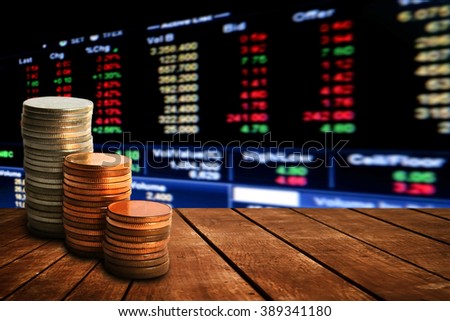 coin stack on old wooden floor with blur perspective stock market number background