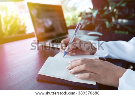 Vintage photo of Handwriting, hand writes a pen in a notebook,soft focus.