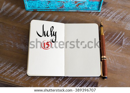 Concept image of July 15 Calendar Day with empty space for text as handwritten note with fountain pen on a notebook