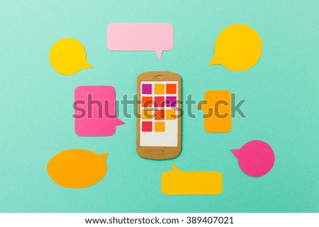 Smart phone with app icons and colorful speechbubbles - mobile communication concept for social networks, messaging apps or multimedia marketing