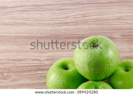 apple crisp cool fresh green five on a wooden table brown close-up with soft focus picture