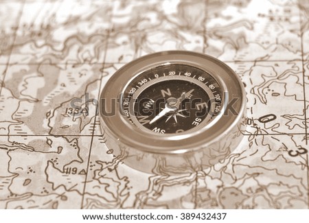 The compass on the map. Magnetic compass is located on a topographic map.