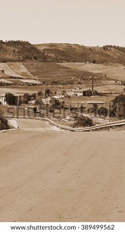 Winding Asphalt Road between Fields of Sicily, Vintage Style Sepia 