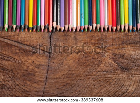 colored pencils on wooden table, copy space