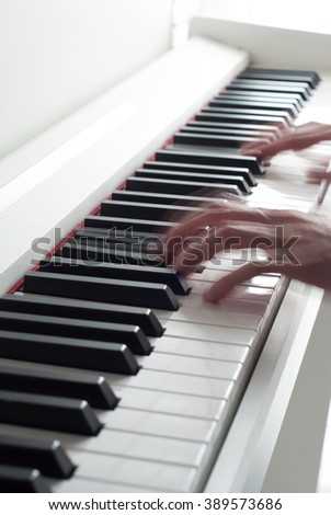 Man playing the piano. Piano keys. Piano playing. Black and white keys. Electronic piano. Musical instrument.