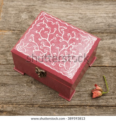 Painted, wooden small boxes for multiple purposes and jewels on a wooden surface                                