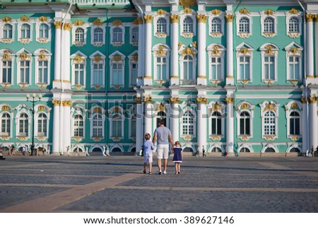 A father with his son and daughter visiting the Hermitage, Saint-Petersburg, in a sunny summer day. Happy family.