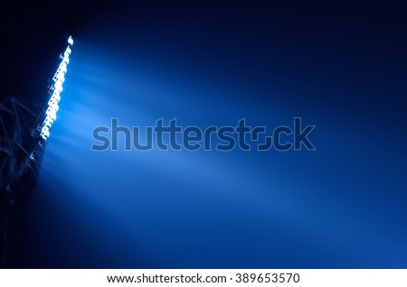 Close-up of stadium floodlights against a dark night sky background Royalty-Free Stock Photo #389653570