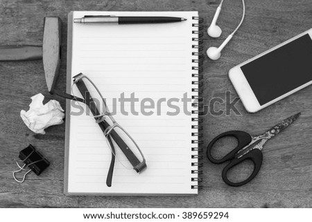 Black and white glasses and pen on notebook