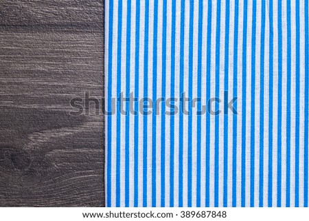 Blue textile, napkin, tablecloth on wooden kitchen table. View from above, top with copy space. Traditional pattern and color.