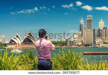 Tourist photographing Sydney skyline, New South Wales, Australia.