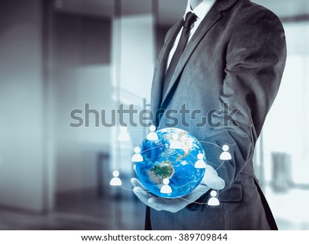 Businessman holding globe in his hands. The concept of personnel management around the world