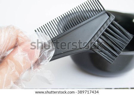 Hand holding a comp for changing Hair Color Royalty-Free Stock Photo #389717434