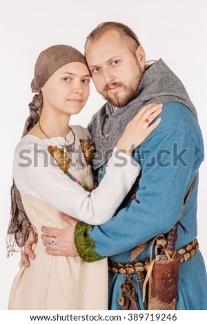 medieval  slavic knight embracing his beautiful wife. image on white studio background. historical concept.