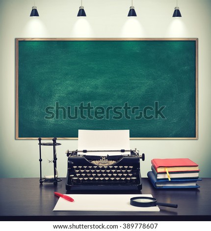 workplace journalist, typewriter with paper and blank blackboard on wall