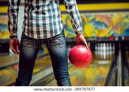 Young man at the bowling alley with the ball