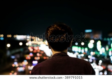 Lonely man in at night and bokeh (blur)