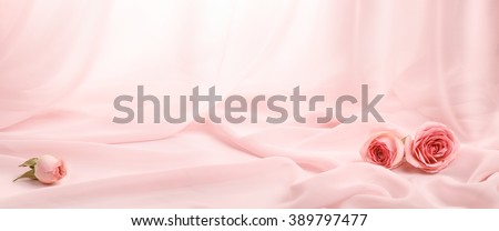 pink roses on soft silk Royalty-Free Stock Photo #389797477